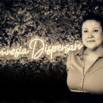 Julietta Neas posing in front of Amnesia Dispensary neon sign