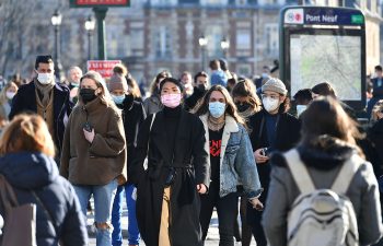 Paris, France-03 06 2021:People wearing protective face masks in a crowded street of Paris, France during the global coronavirus epidemic.