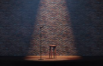 Empty stand-up stage with a microphone and bricks on background. 3d illustration