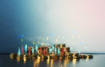 Shiny gold coins stacked on table with candlestick chart overlay, symbolizing cryptocurrency trading, financial market investment, forex analysis, digital economy, and long term wealth growth strategy